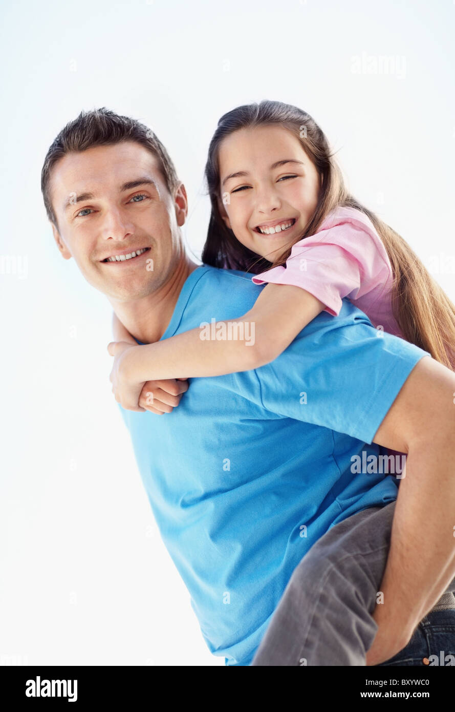 Father carrying daughter on back Stock Photo