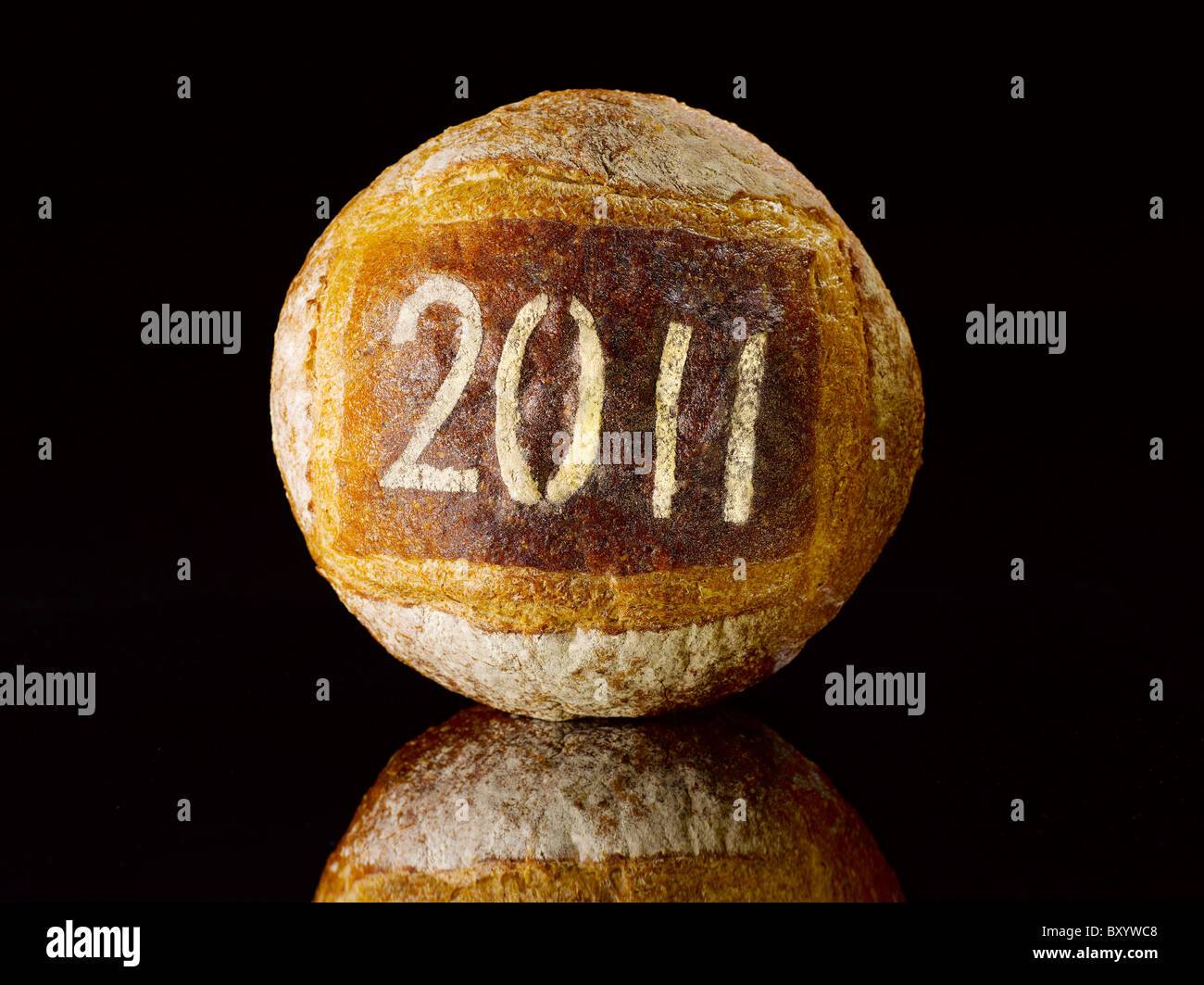 round loaf of bread dusted with the new year date 2011 Stock Photo