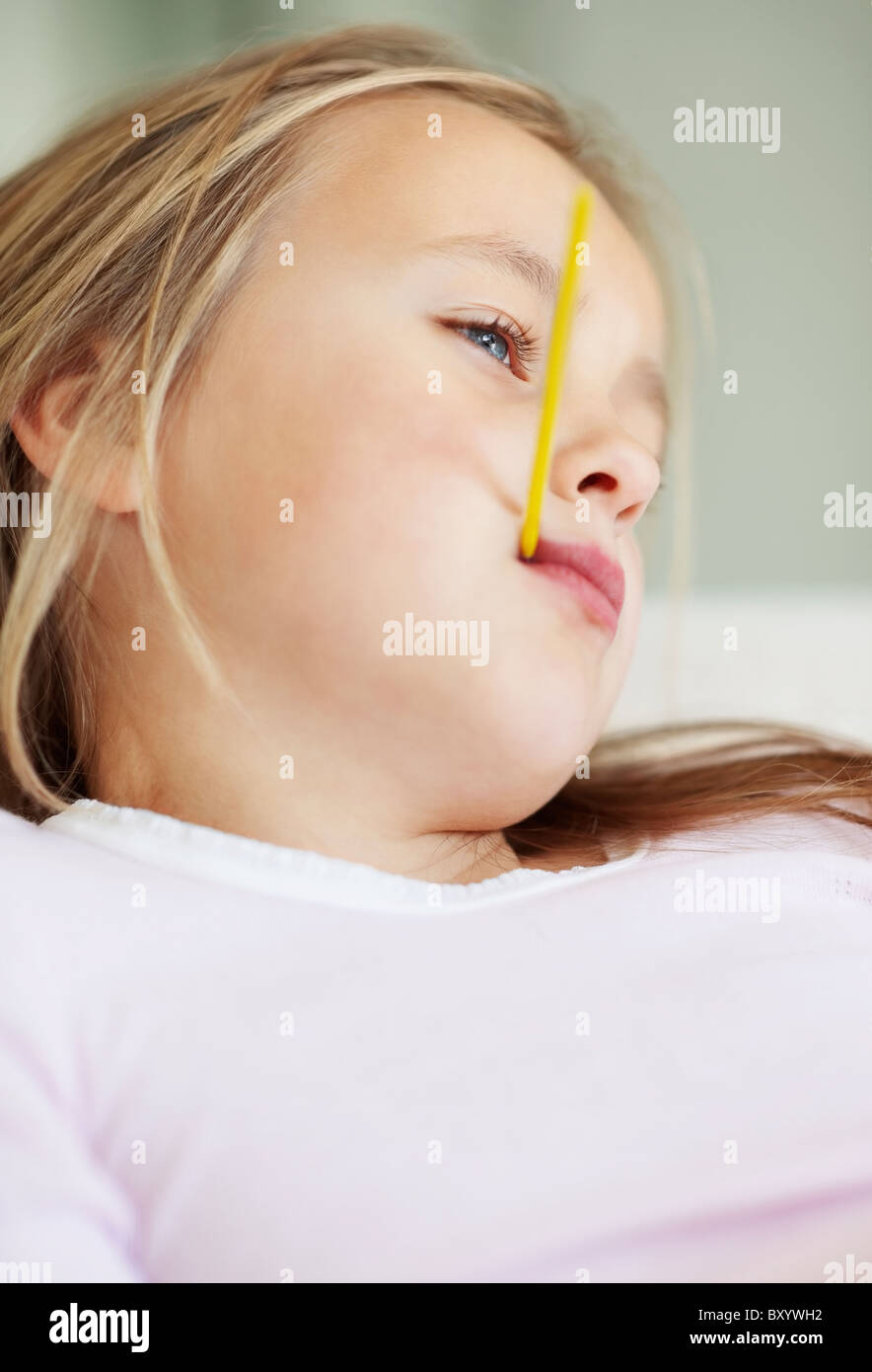 Girl checking temperature with thermometer Stock Photo - Alamy