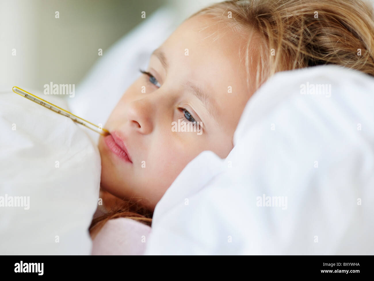 Girl checking temperature with thermometer Stock Photo Alamy