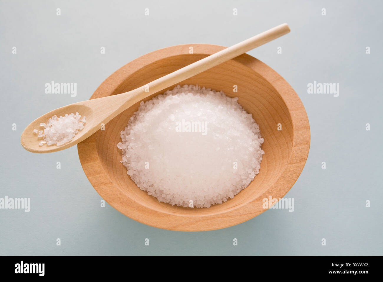 Salt in wooden bowl with spoon Stock Photo