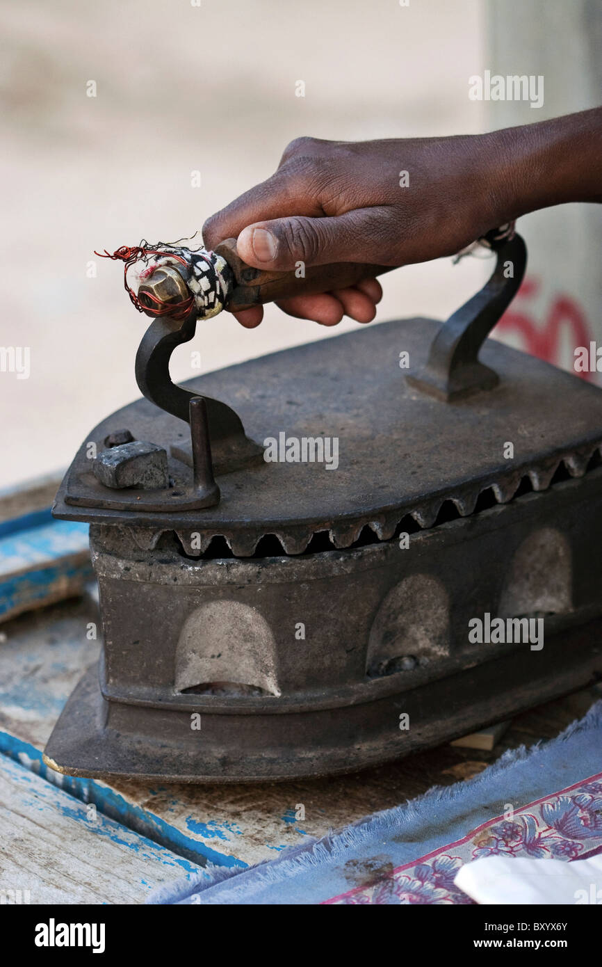 https://c8.alamy.com/comp/BXYX6Y/traditional-clothes-iron-fired-by-hot-coals-andhra-pradesh-state-south-BXYX6Y.jpg