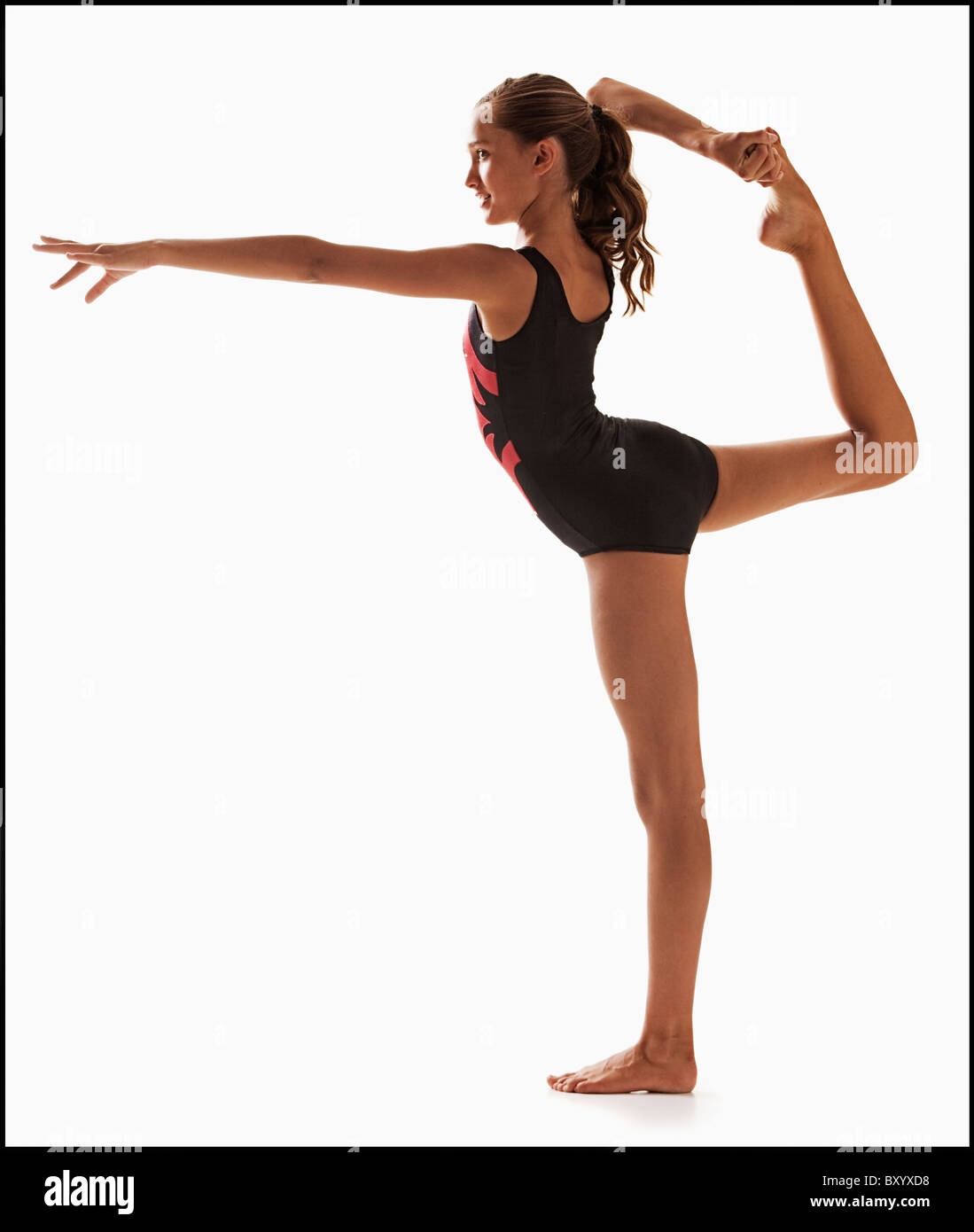 Female gymnast balancing on one leg Stock Photo