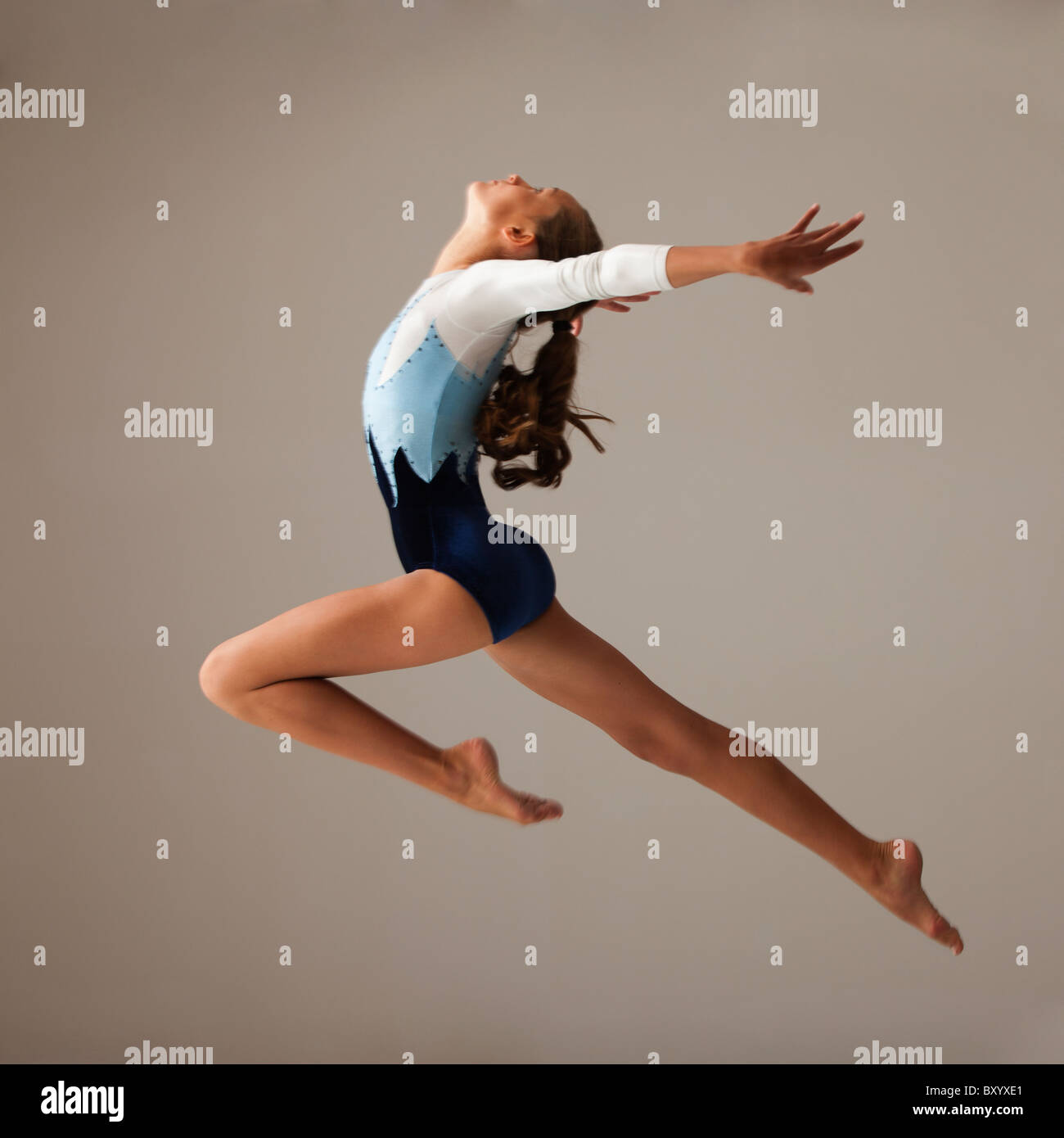 Female gymnast leaping Stock Photo