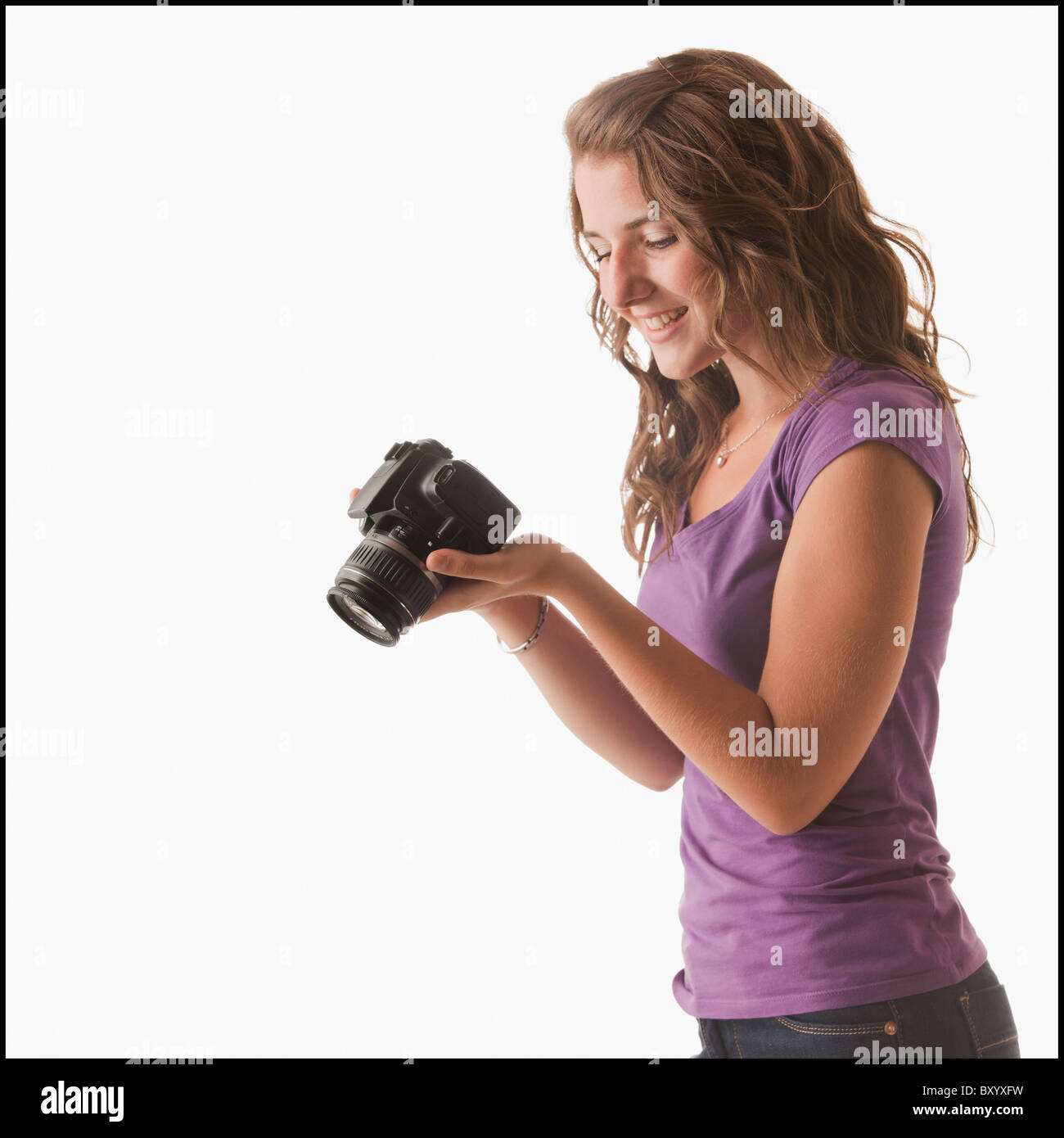 Young woman holding camera Stock Photo - Alamy
