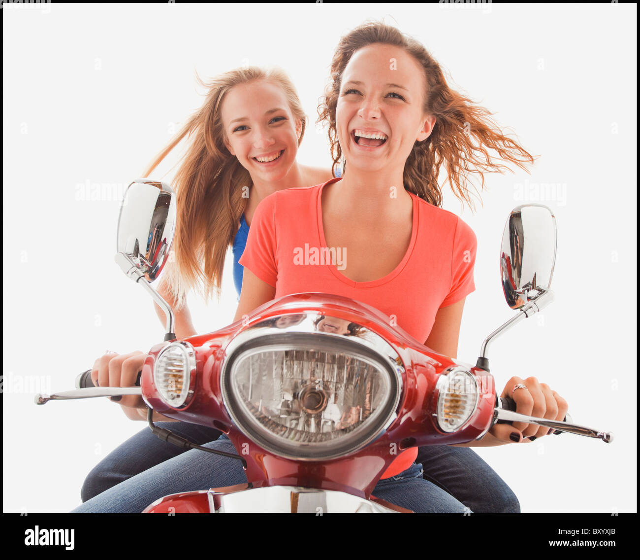 Young girls riding scooter Stock Photo