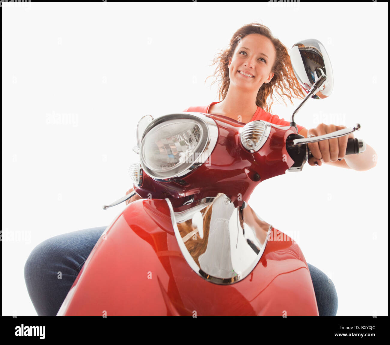 Young girl riding scooter Stock Photo