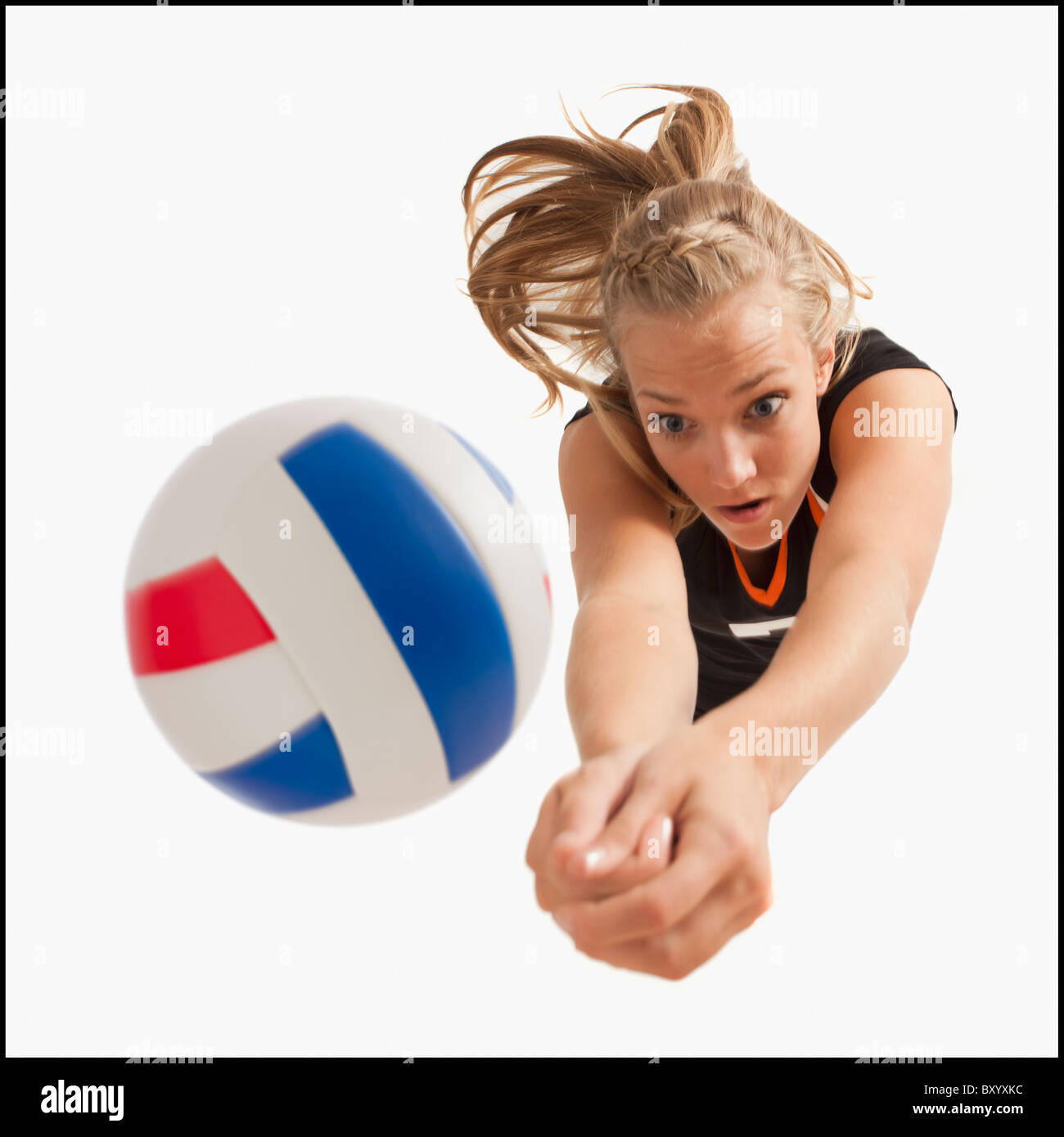 Young girl playing volleyball Stock Photo