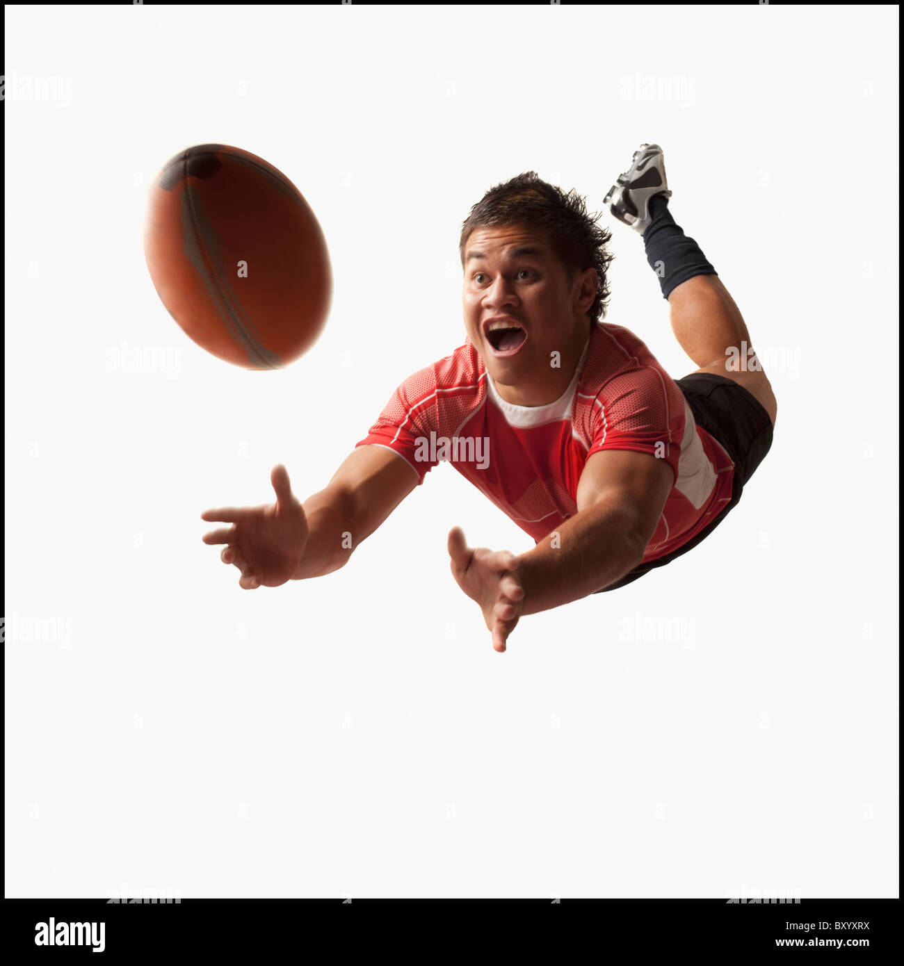 Male rugby player diving for ball Stock Photo