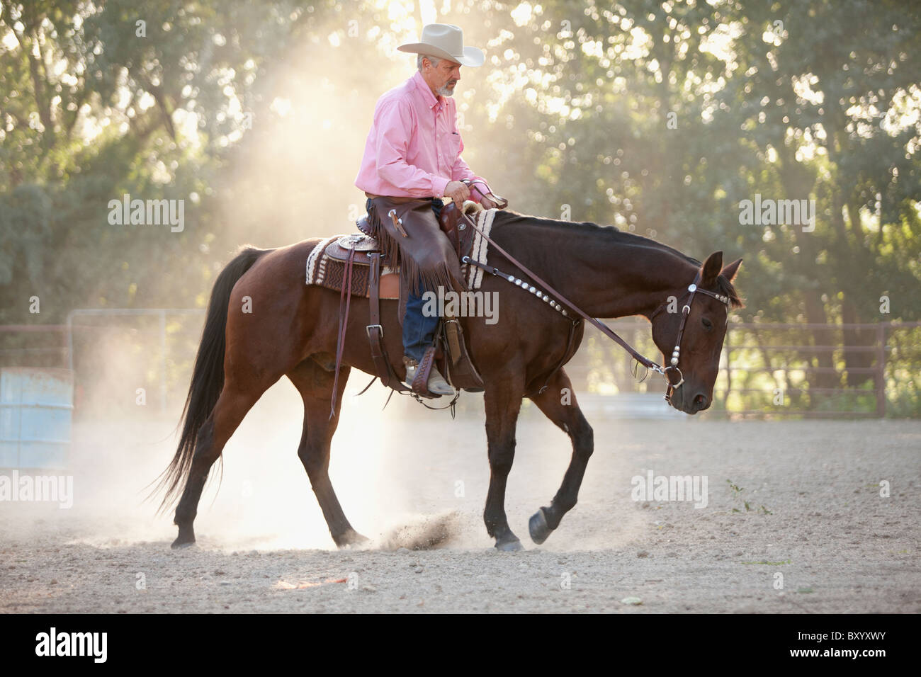 Senior man horseback riding in ranch Stock Photo