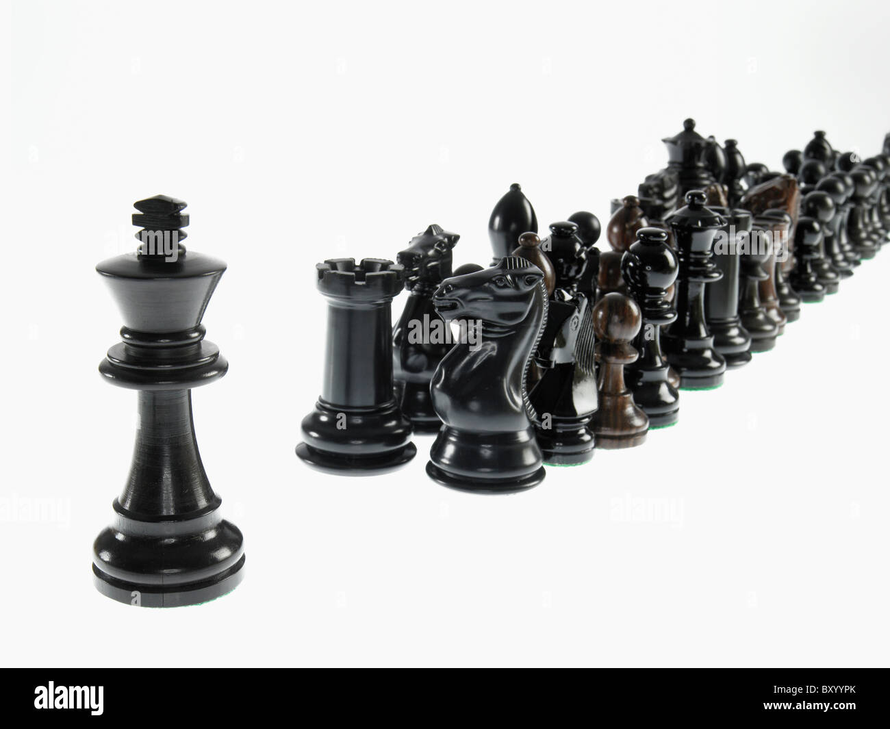 King leading black chess pieces Stock Photo