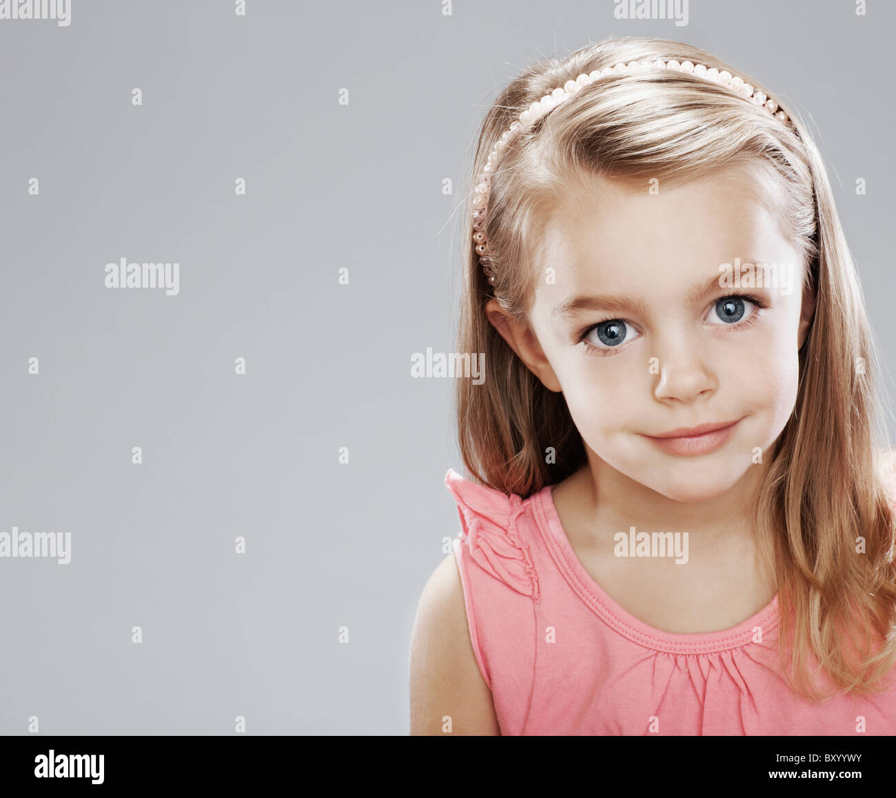 Studio portrait of girl smiling Stock Photo - Alamy