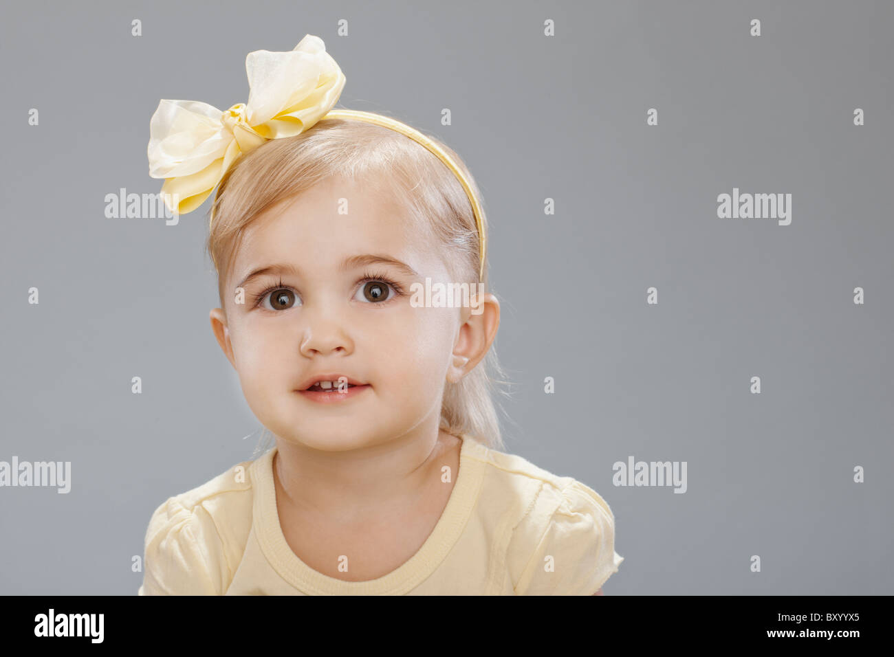Studio portrait of girl smiling Stock Photo - Alamy