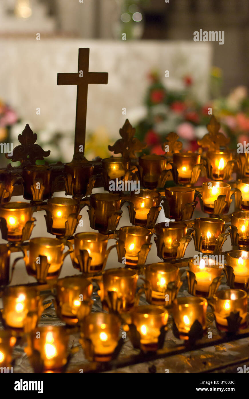Cross with candles in cathedral Stock Photo Alamy