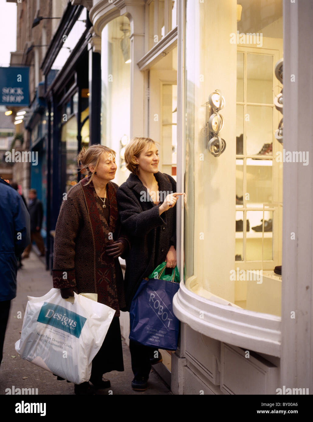 A mother and daughter out shopping in London in England in Great Britain in the United Kingdom UK. Family Shopping Consumer Stock Photo