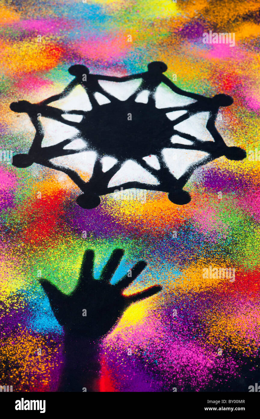One world unity symbol surrounded by childrens hand prints made with multicoloured powder Stock Photo