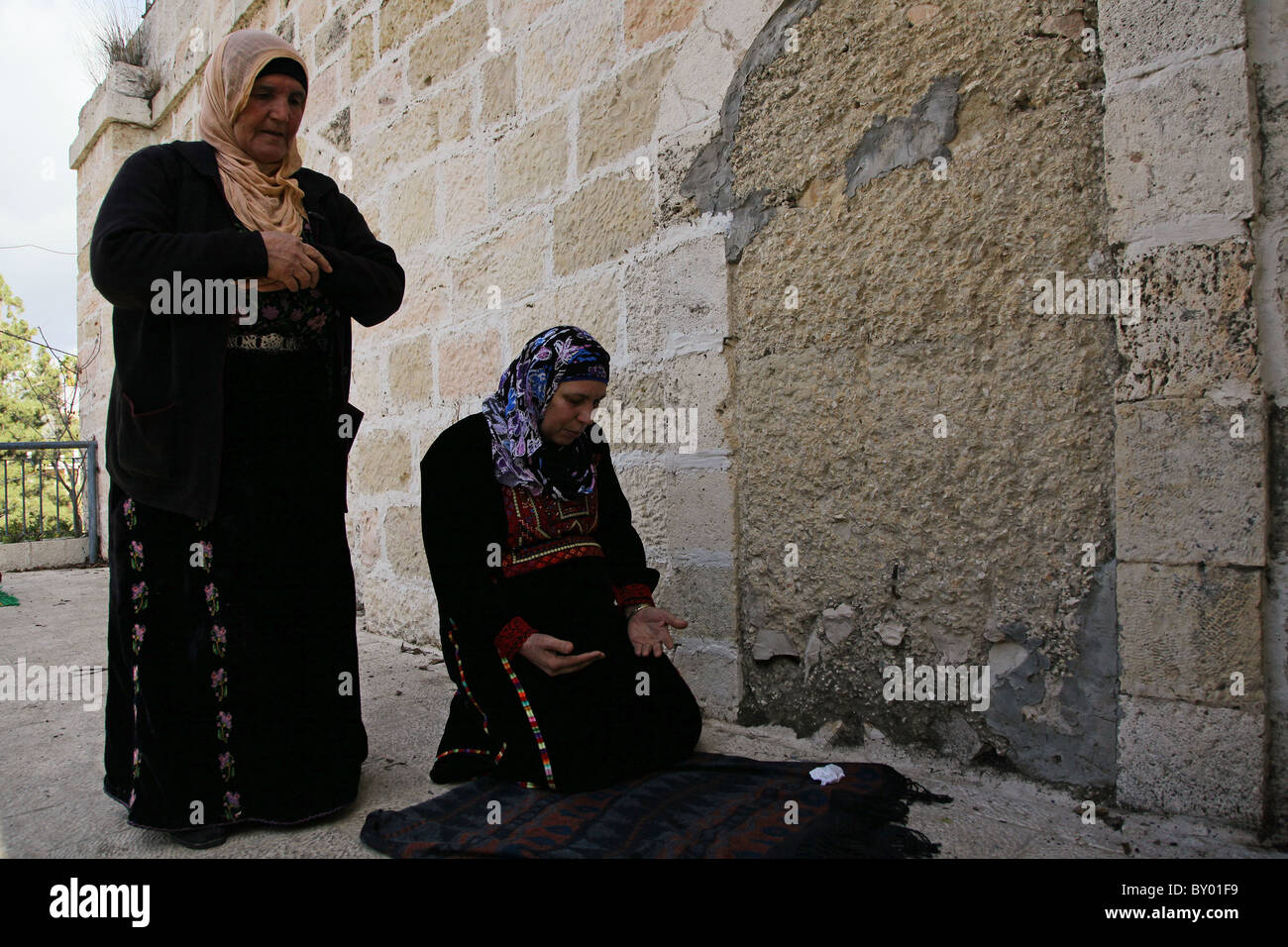 Palestinian women praying as they revisits their family's village in Ein Karem or Ain Kerem a neighborhood in southwest Jerusalem which was depopulated by Arab inhabitants and repopulated by Jewish immigrants during the 1948 Arab-Israeli War. Israel Stock Photo
