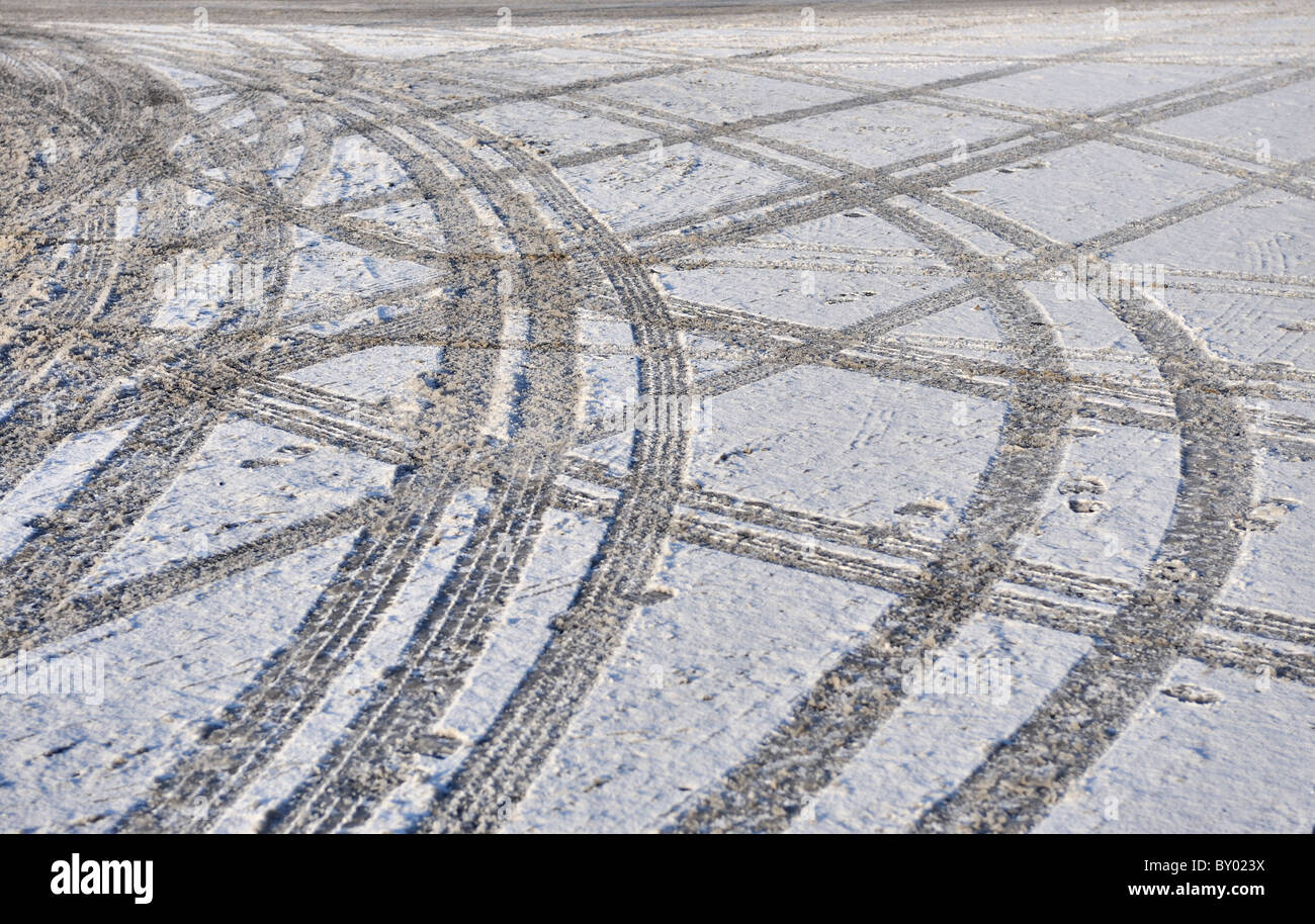 Tyre tracks left on a snowy and icy road Stock Photo - Alamy