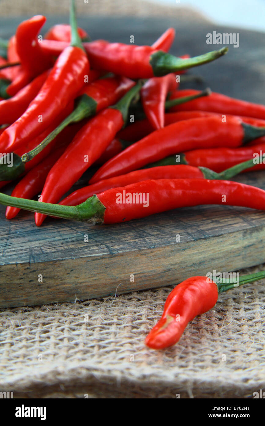 Red hot chili peppers over wooden background Stock Photo - Alamy