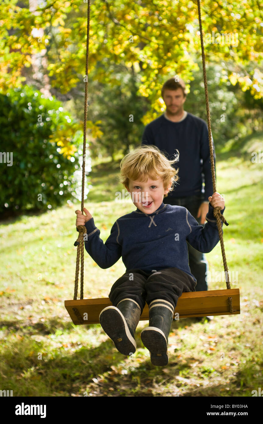 Pushed child on swing hires stock photography and images Alamy