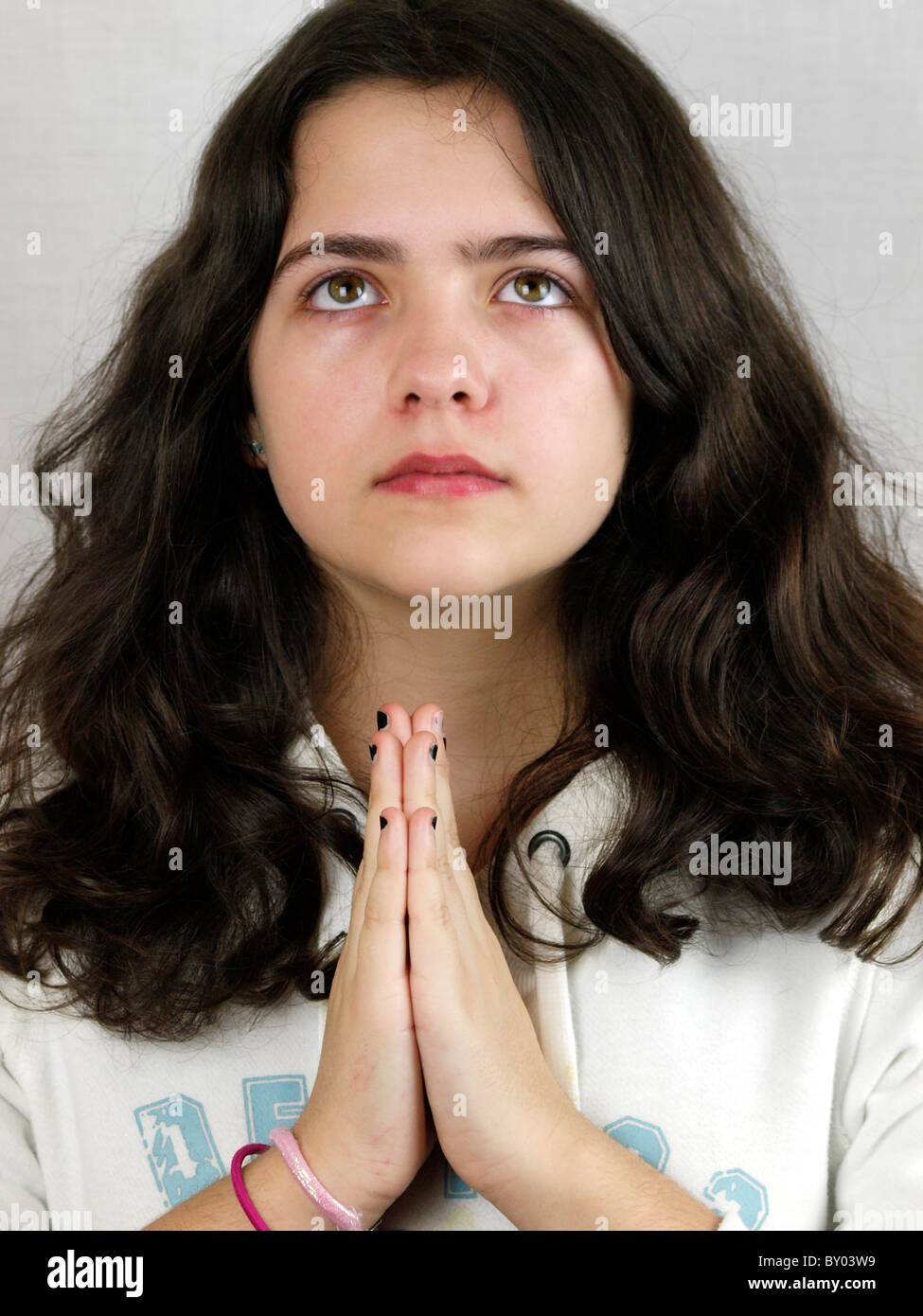 Young teen girl praying, UK Stock Photo