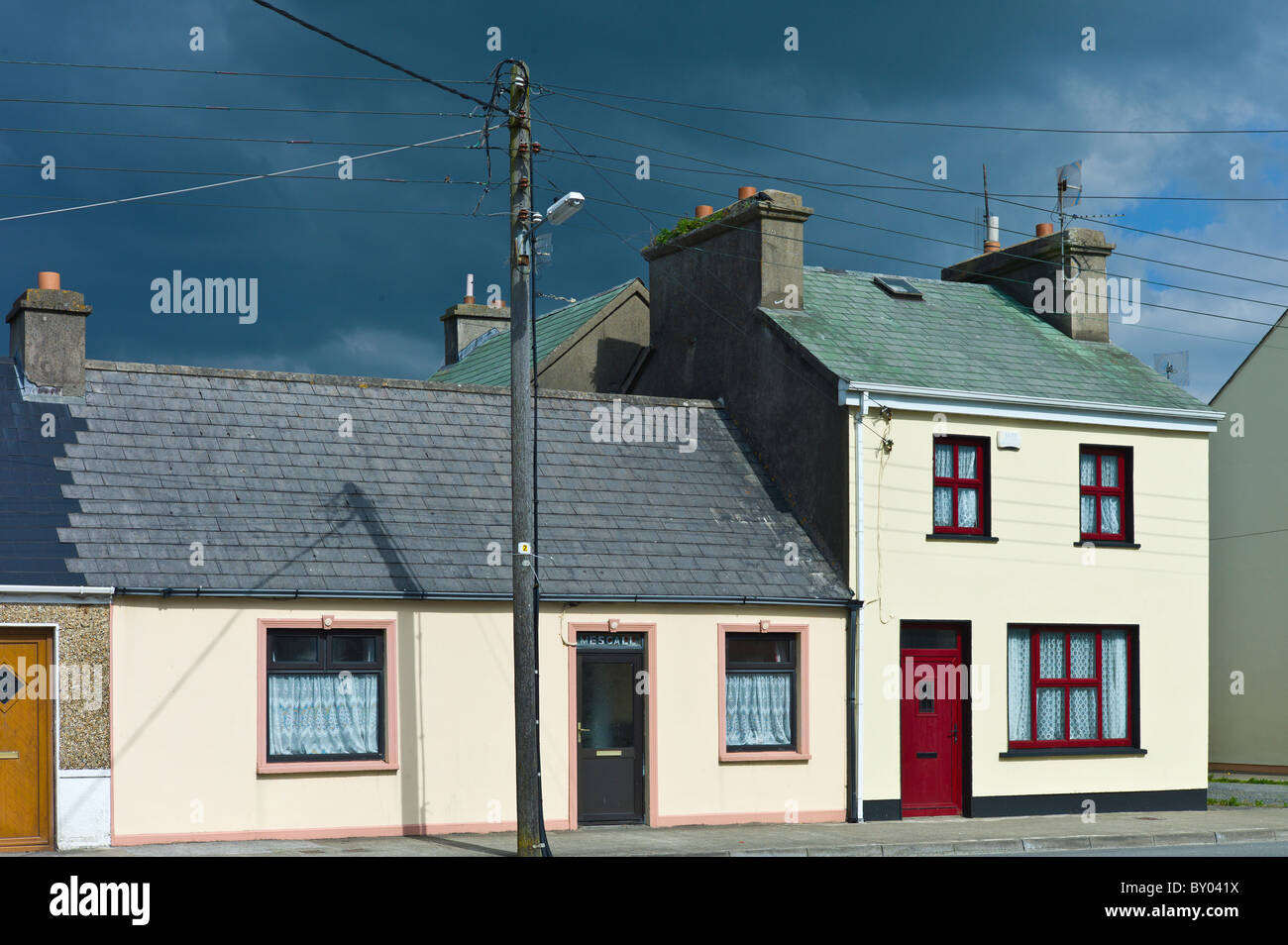 Street scene pastel painted terraced homes in Kilkee, County Clare, West of Ireland Stock Photo