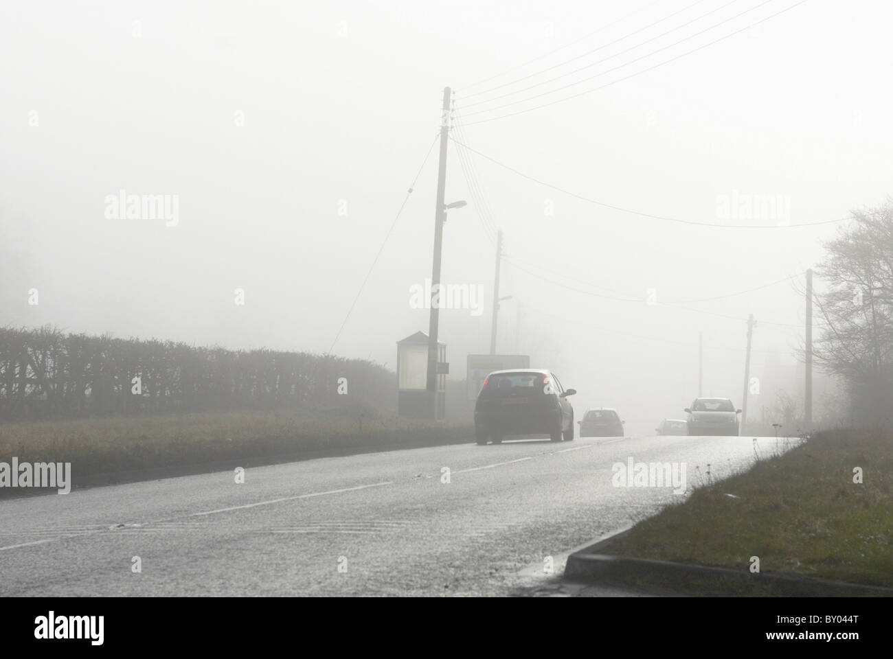 Cars driving in fog UK Stock Photo Alamy