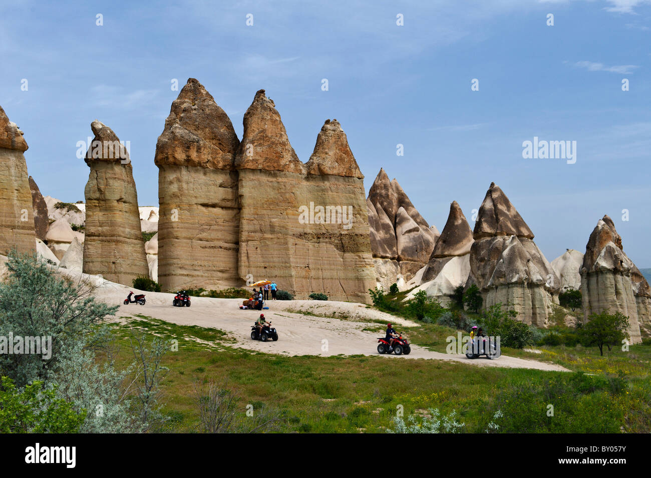 Tourists driving atvs between Fairy chimneys in Lovers Valley Cappadocia Turkey Stock Photo
