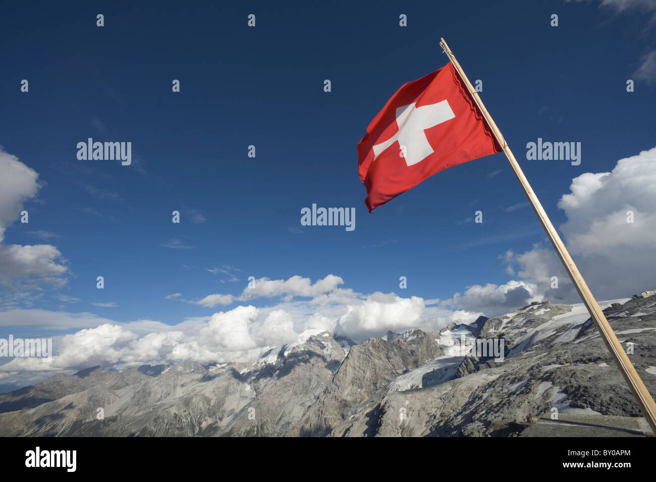 The Swiss national flag flying at the refuge on the Stelvio Pass between Italy and Switzerland Stock Photo