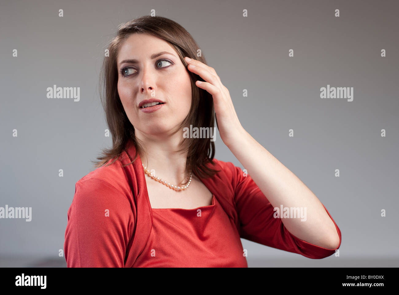 Portrait of a young pretty woman wearing a red top Stock Photo