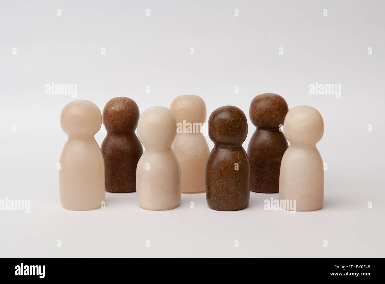 Brown and white figures, mixed together in one group Stock Photo