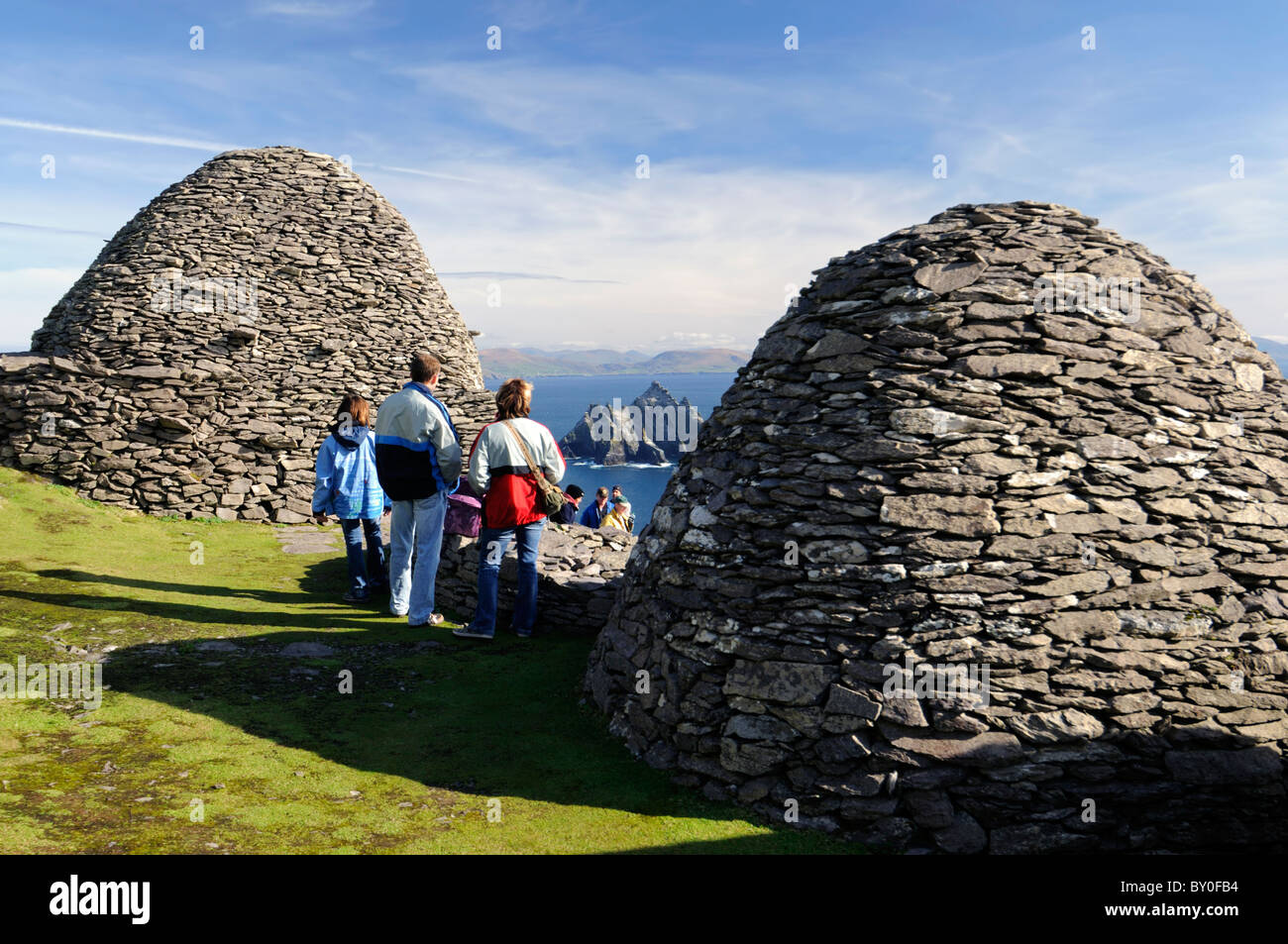 Skellig Michael Ancient Celtic monastic island settlement island County Kerry ireland Hermitage beehive huts tourists looking Stock Photo