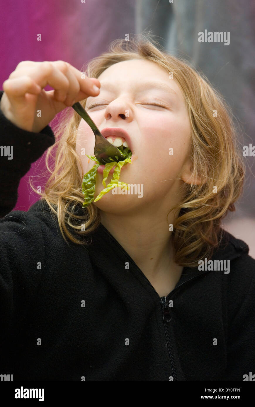 Eleven year old girl eating cabbage Stock Photo Alamy