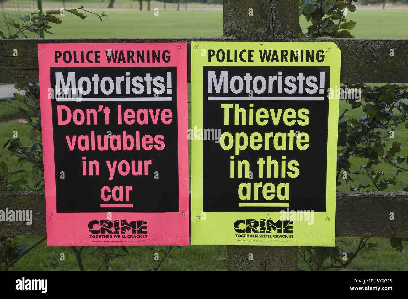 Two posters pinned to a fence, warning motorists about car crime. Stock Photo