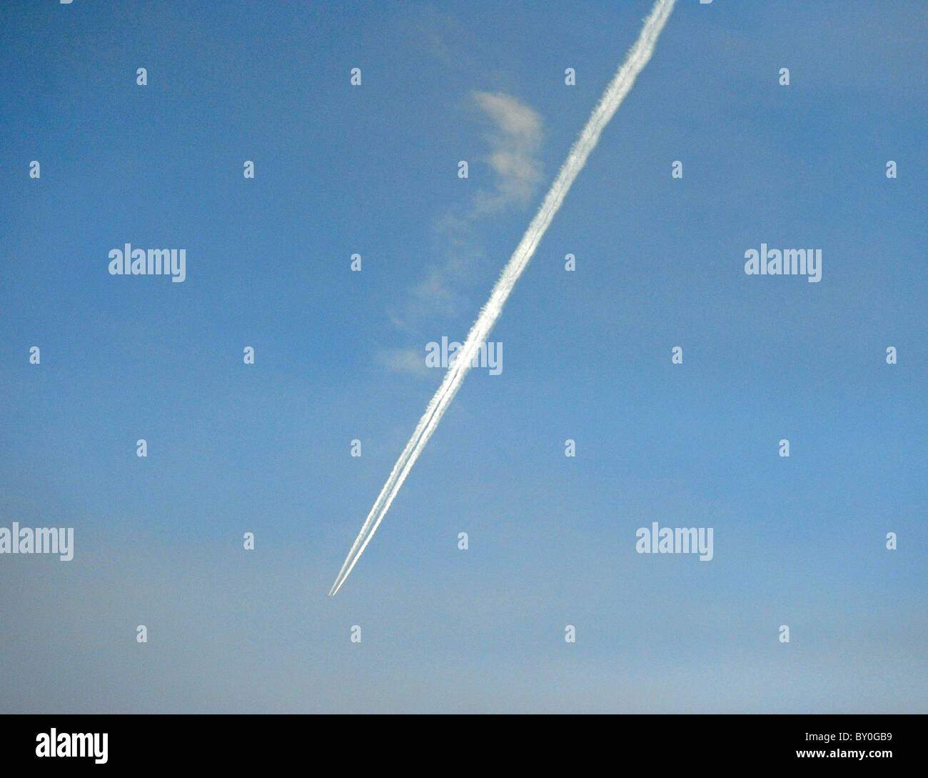 Jet airliner aeroplane vapour trail against blue sky Stock Photo