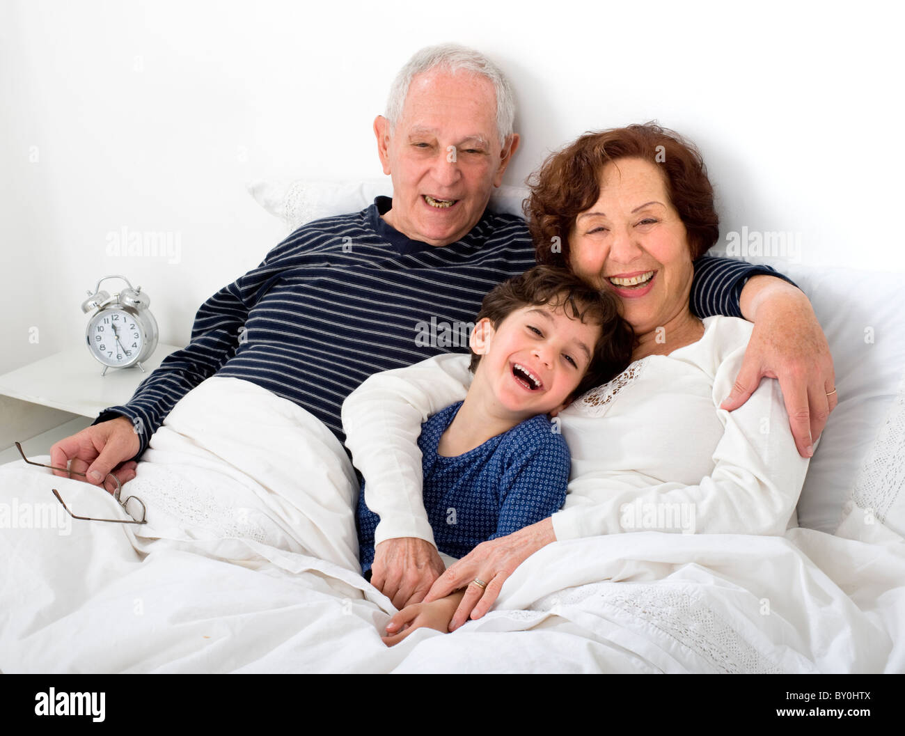 grandparents and grandchild in bed together Stock Photo Alamy