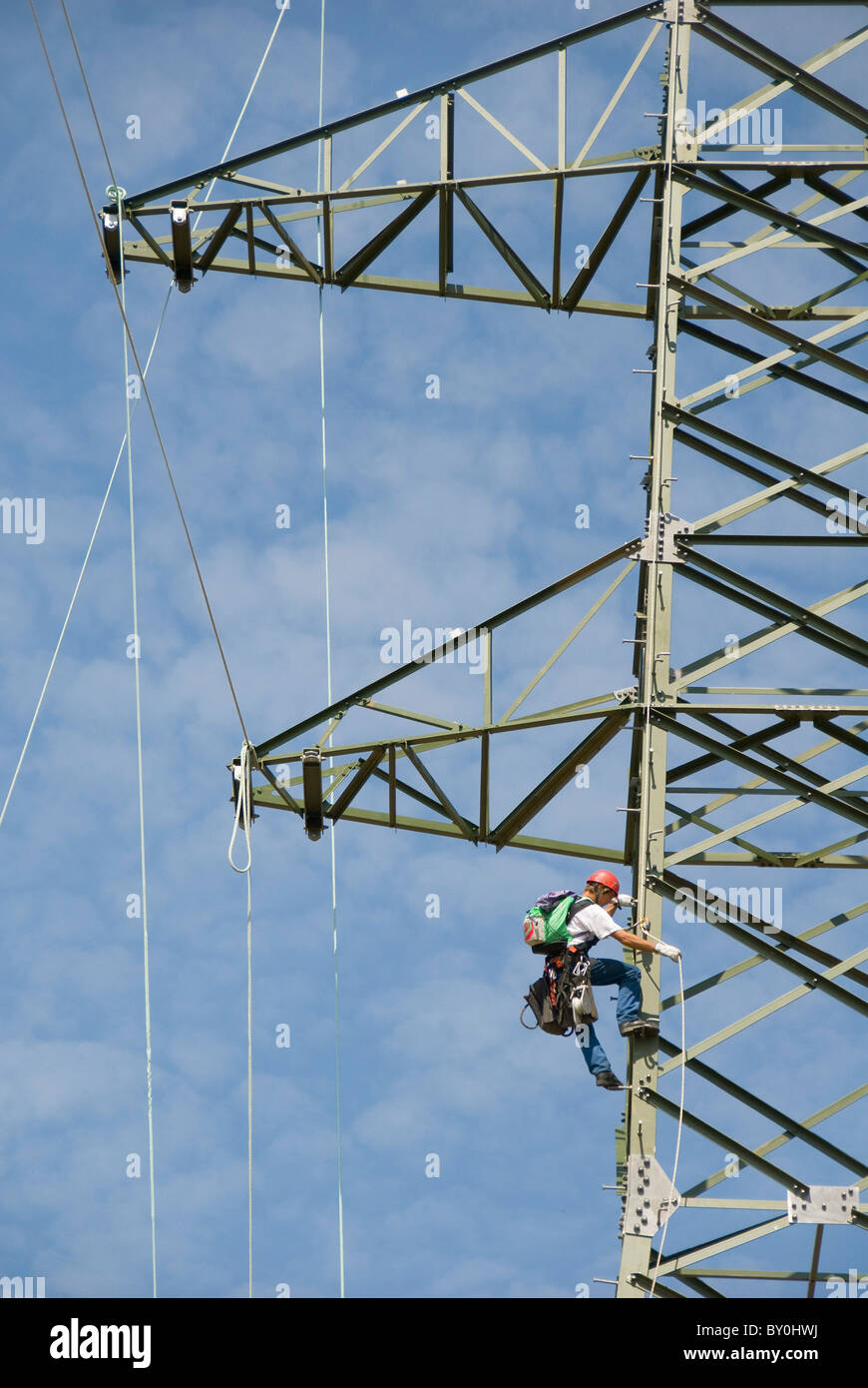 Worker climbing an electricity pylon, Austria, Europe Stock Photo