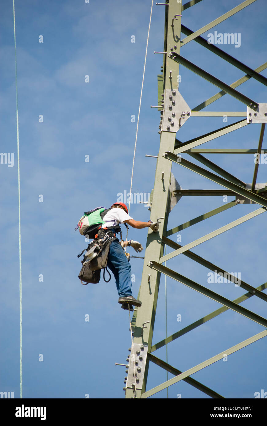 Worker climbing an electricity pylon, Austria, Europe Stock Photo