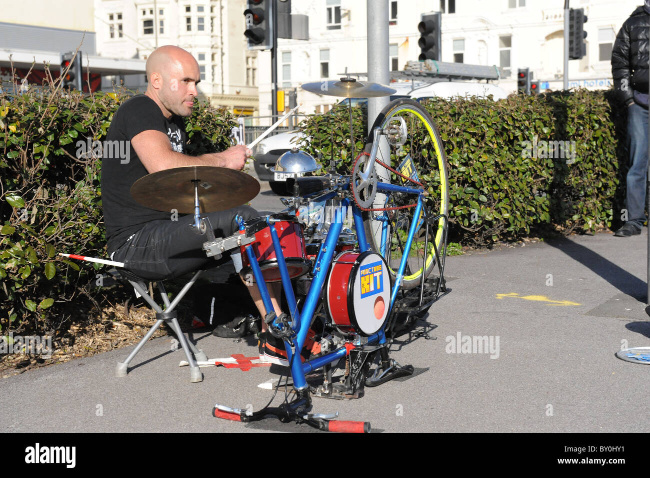 Busker on Brighton Seafront plays drums on a converted bicycle Stock