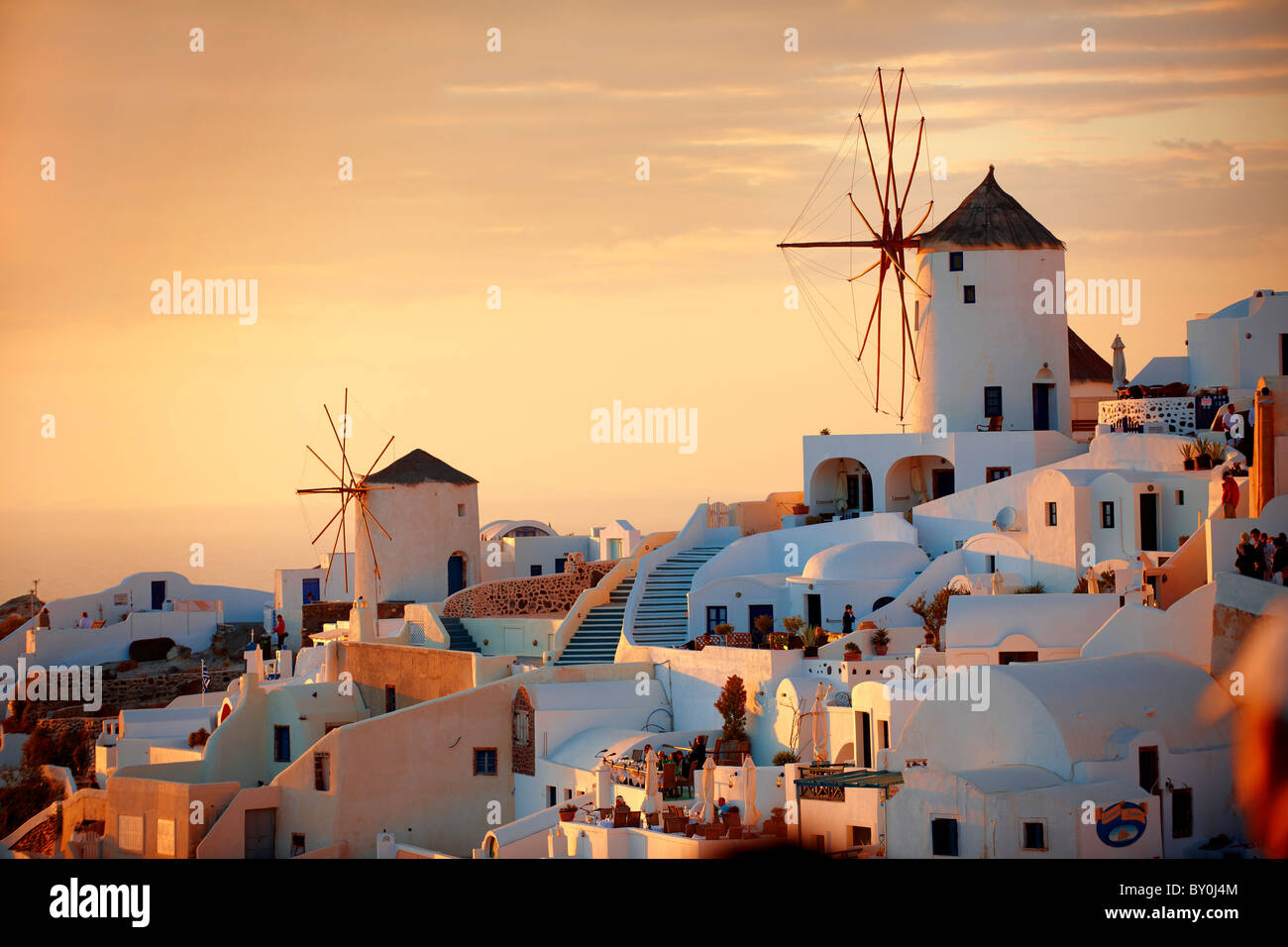 Oia ( Ia ) Santorini - Windmills and town at sunset, Greek Cyclades islands - Photos, pictures and images Stock Photo