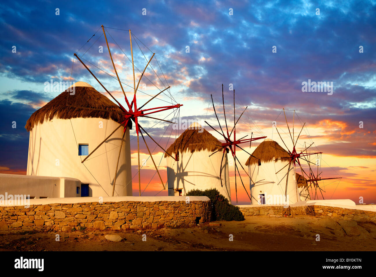 Sunset over the traditional Greek windmills of Mykonos Chora. Cyclades Islands, Greece Stock Photo