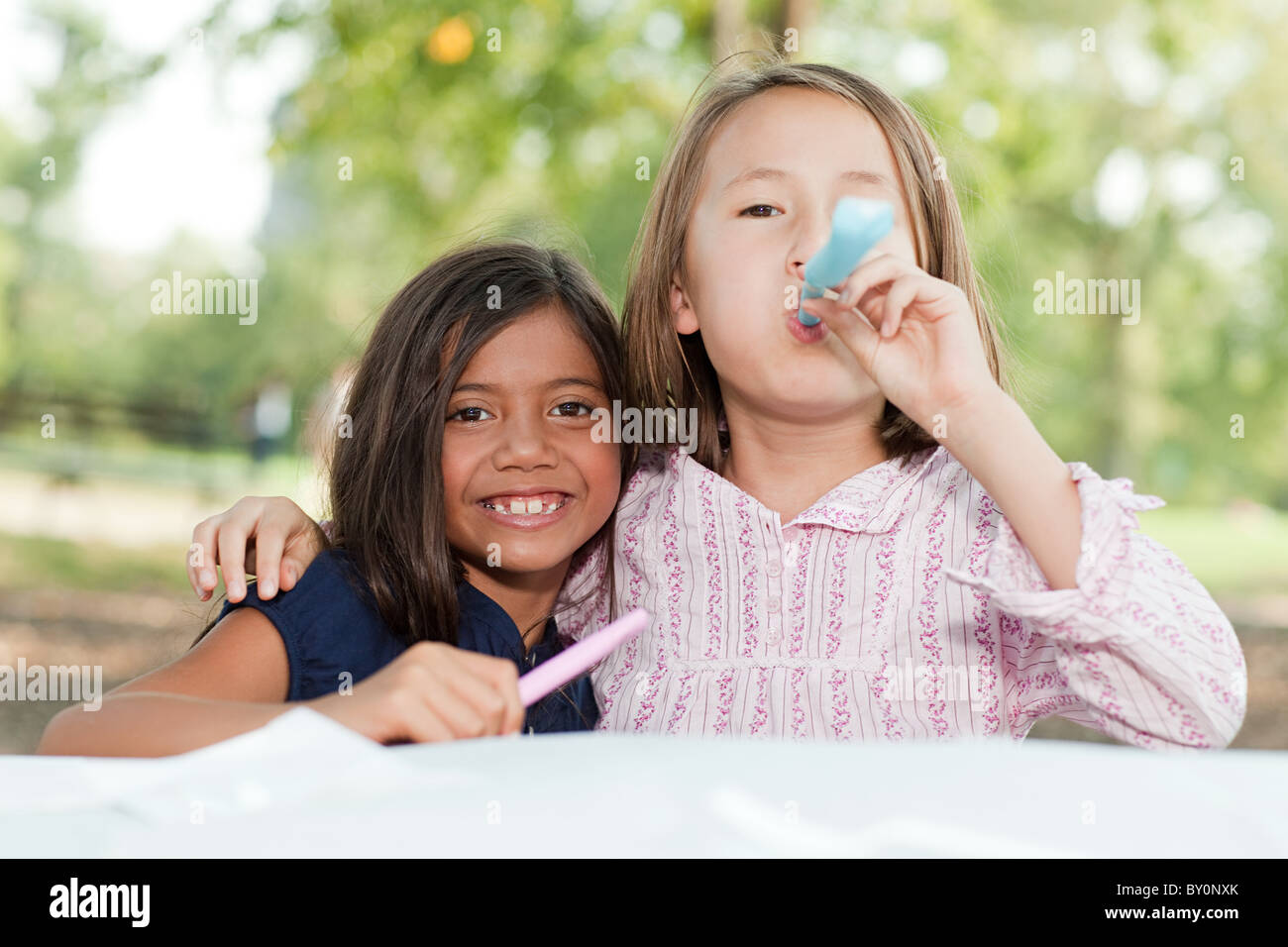 Girls at birthday party with party blowers Stock Photo - Alamy