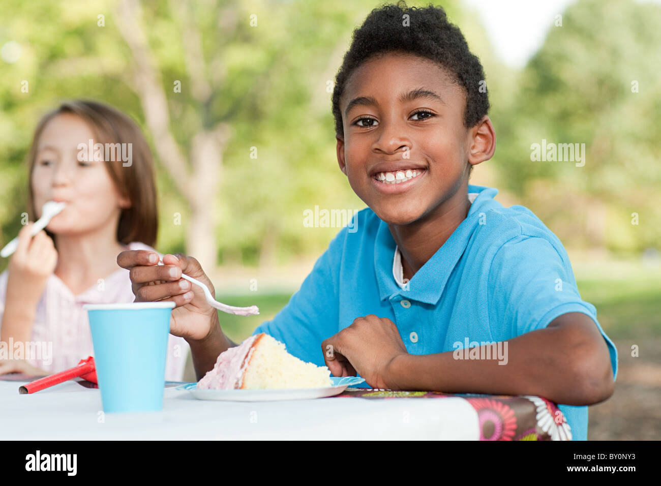 Boy at birthday party eating birthday cake Stock Photo - Alamy