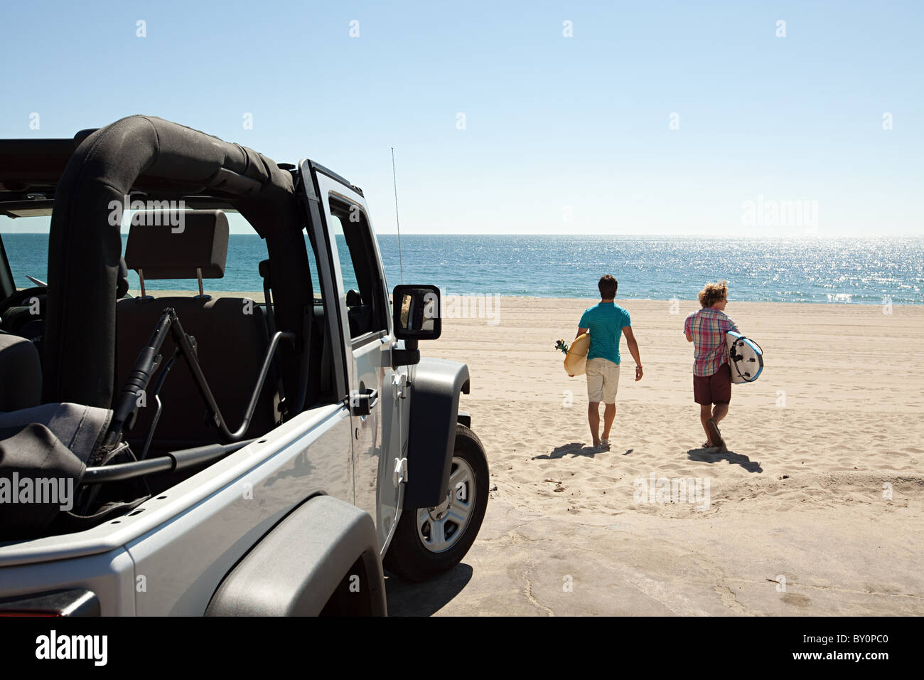Surfers and SUV Stock Photo