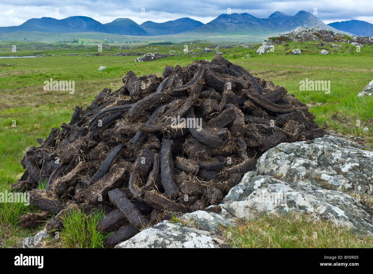 Stacked peat in turf bog on the Old Bog Road near Roundstone, Connemara, County Galway Stock Photo