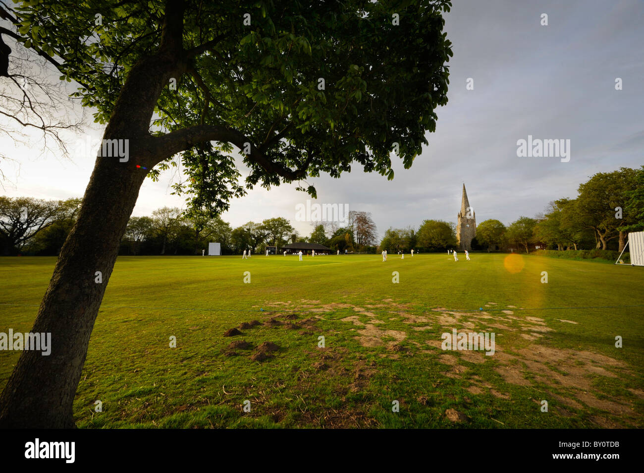 Rural Sussex: players in action on the village cricket pitch in Chiddingly. Picture by Jim Holden. Stock Photo