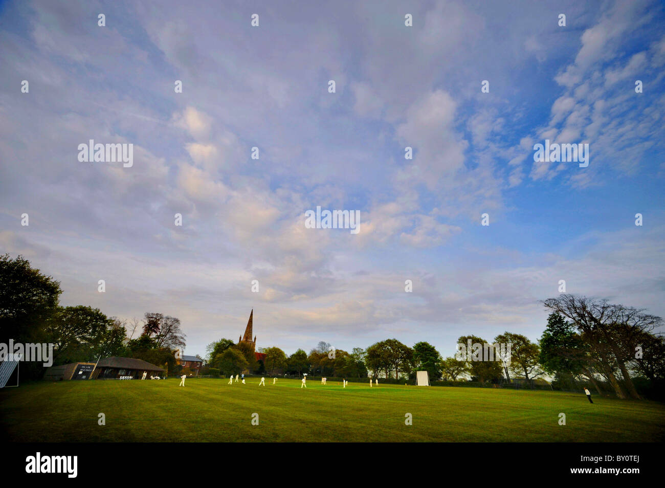 Rural Sussex: players in action on the village cricket pitch in Chiddingly. Picture by Jim Holden. Stock Photo