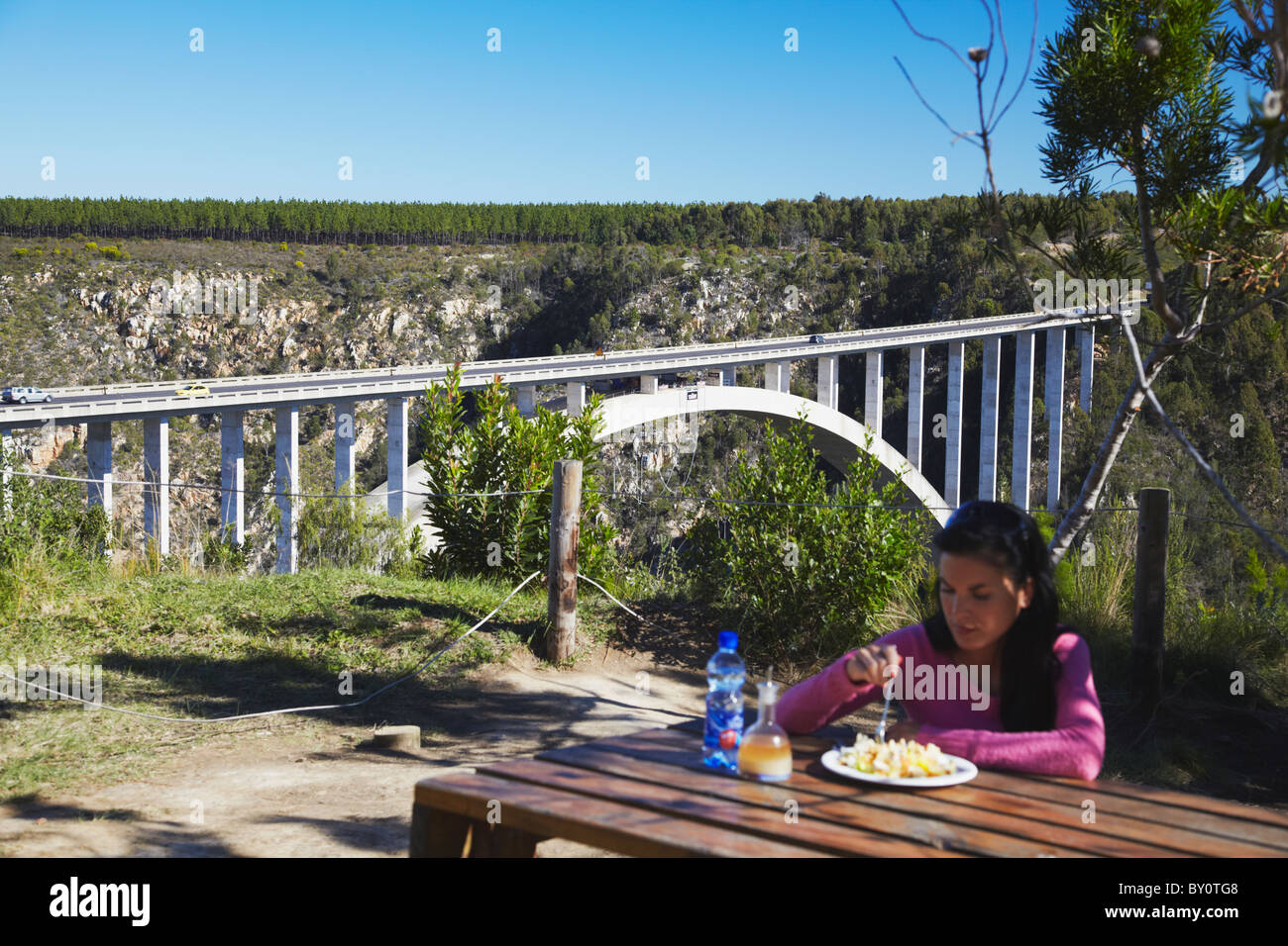 Woman eating lunch next to Bloukrans River Bridge, Eastern Cape, South Africa Stock Photo