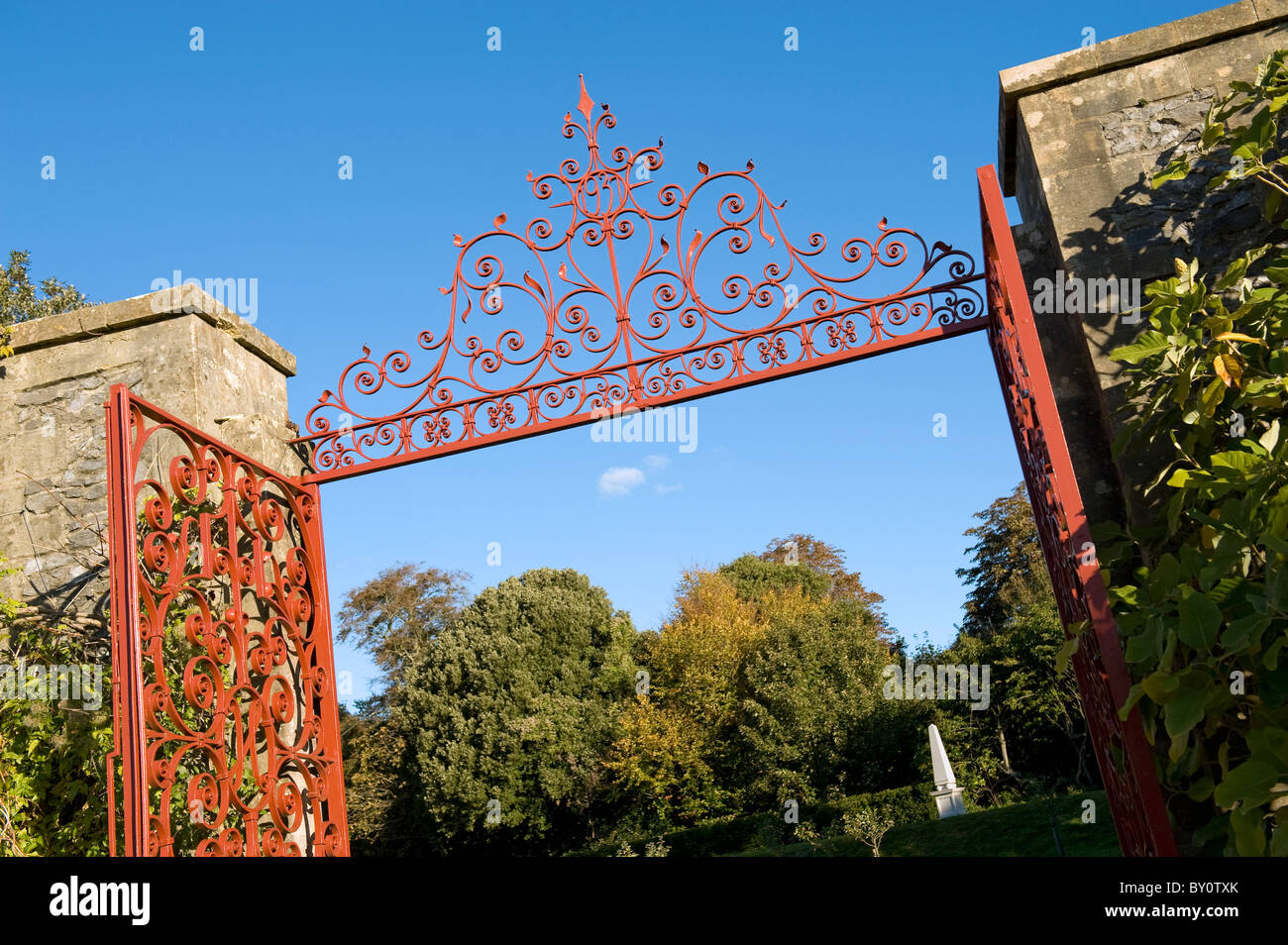 Red intricate wrought iron entrance gate to Arundel Castle Gardens 'The Collector Earl's garden', Erected 1937, West Sussex, UK Stock Photo