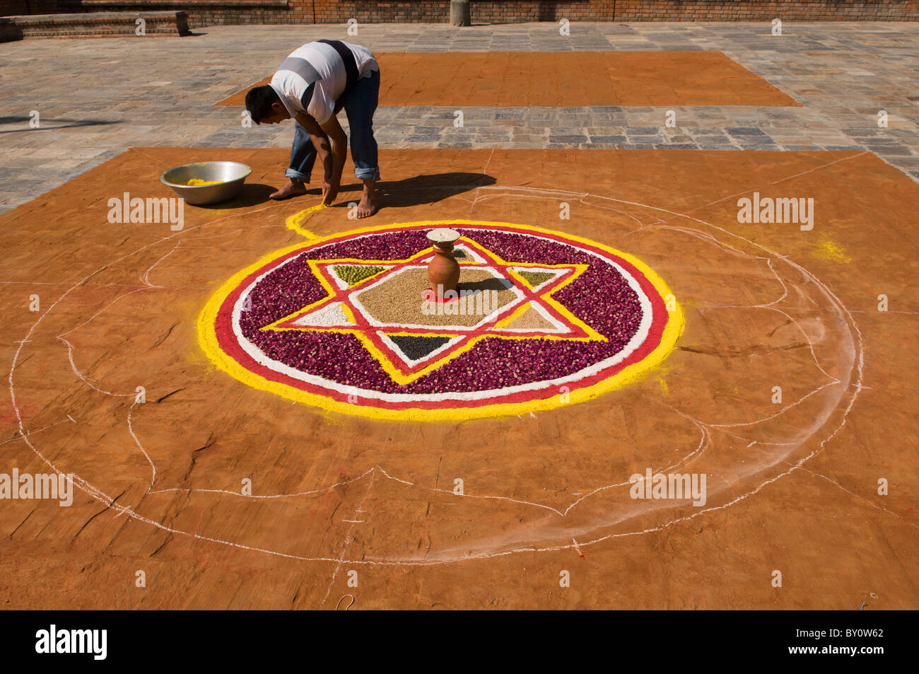 creating a mandala for the Tihar Festival in Kathmandu, Nepal Stock